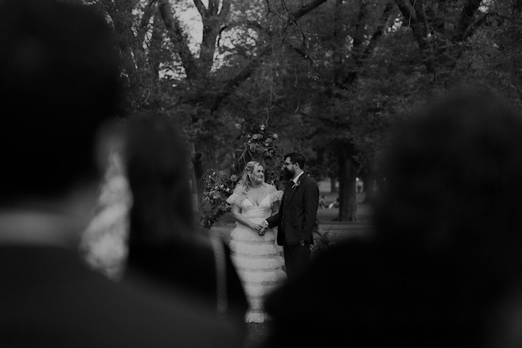 034_couples standing at ceremony in fitzroy gardens circle of trees