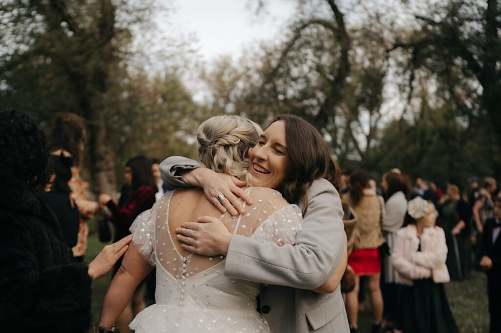 056_guests hugging couple at Edinburgh Gardens Fitzroy wedding