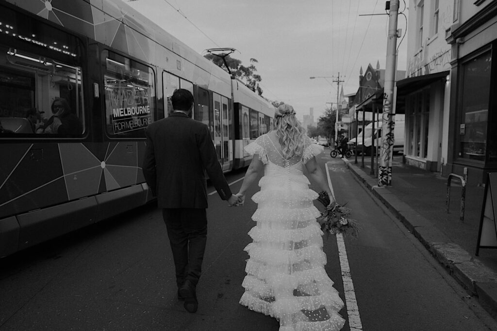 080_couple getting on tram after wedding ceremony Edinburgh Gardens Fitzroy