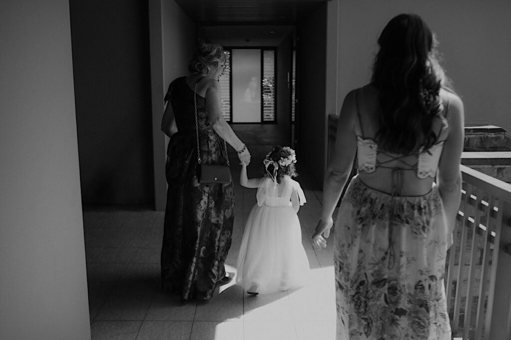 021_flower-girl-natadola-bay-wedding The flower girl walking toward the bride during a wedding at Natadola Bay, Fiji, capturing a sweet and joyful moment before the ceremony