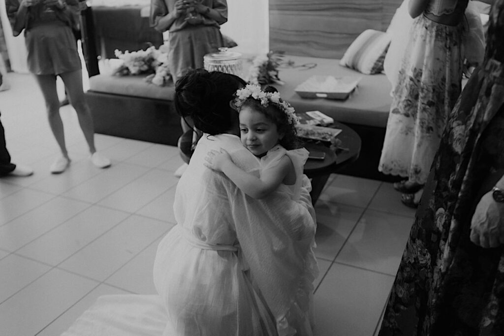 022_flower-girl-hugs-bride-at-intercontinental-resort-fiji A heartfelt moment as the flower girl hugs the bride at the InterContinental Resort, Fiji, during their wedding celebration