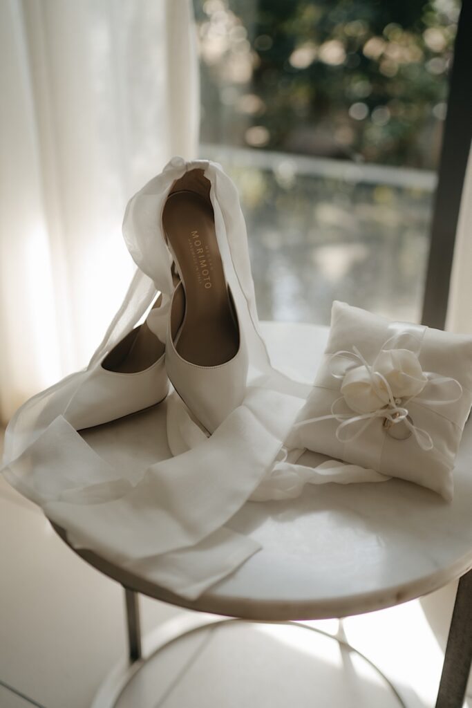026_brides-details-at-fiji-intercontinental-resort The bride’s details at the InterContinental Resort, Fiji, featuring her shoes, wedding rings, and other elegant accessories