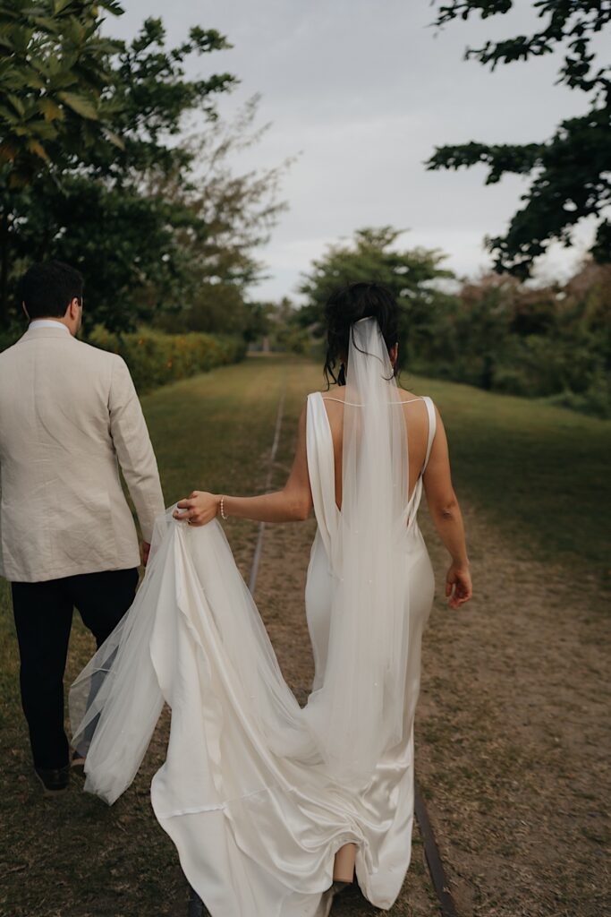 154_couple-walking-natadola-bay-wedding-intercontinental Couple walking hand in hand along railway at Natadola Bay, during their wedding at the Intercontinental Resort in Fiji