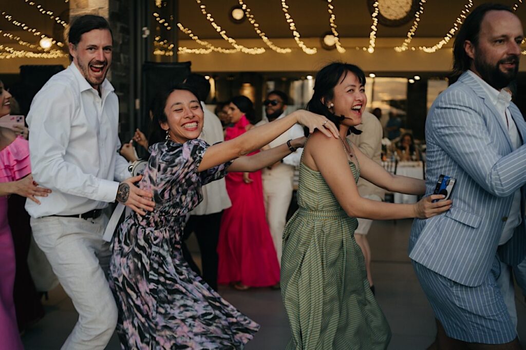 195_guests-dancing-navo-reception-wedding Guests dancing at the Navo reception during the wedding in Fiji, pulling funny faces