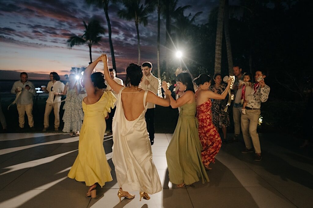 229_guests-dance-after-couple-first-dance-fiji-wedding Guests dancing and celebrating after the couple’s first dance at a Fiji wedding, enjoying the lively atmosphere on the dance floor