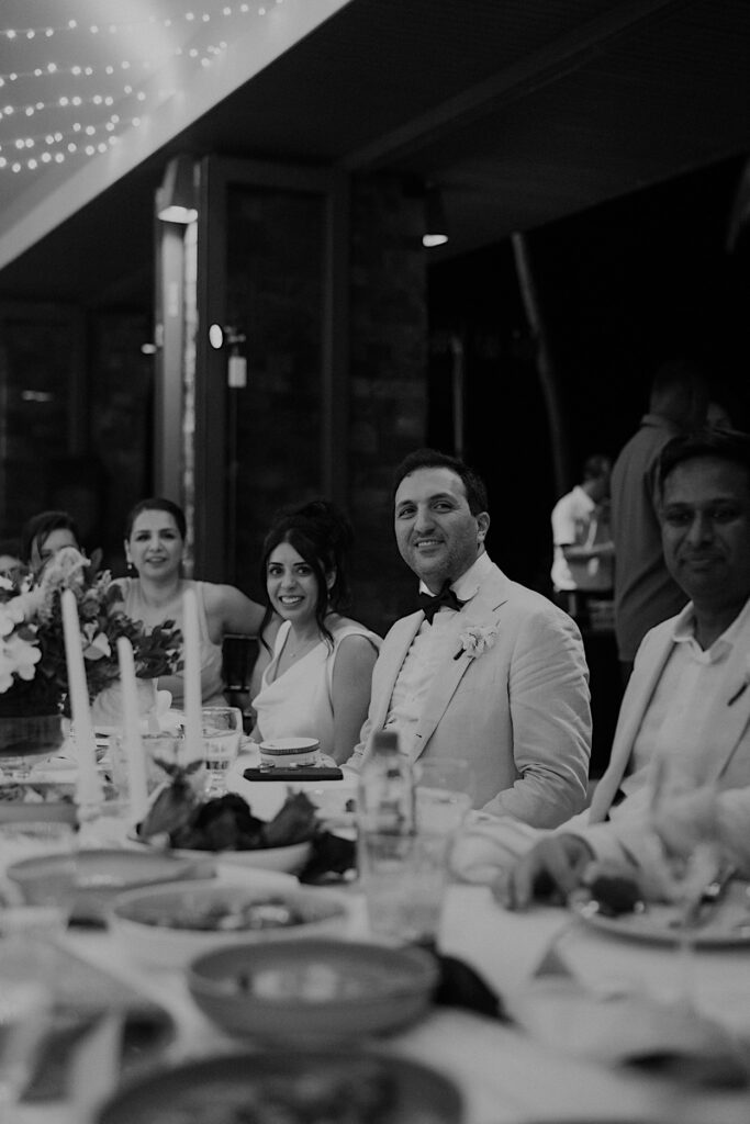250_couple-speeches-wedding-navo-reception-fiji Black and white image of the couple listening to speeches during their wedding reception at Navo Restaurant, Intercontinental Resort, Fij
