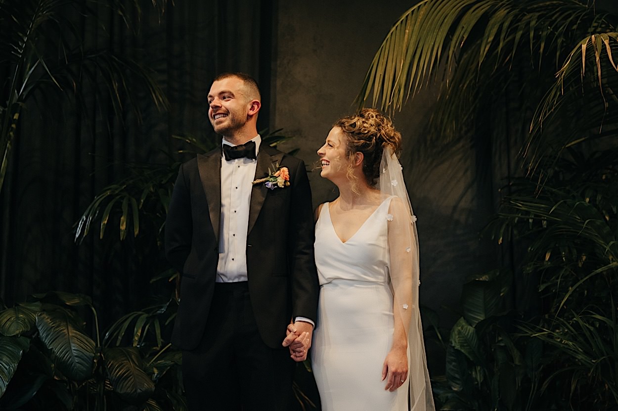 083_bride-groom-laughing-glasshaus-brucke Bride laughing while looking at the groom during the ceremony at Glasshaus Brucke wedding in Melbourne