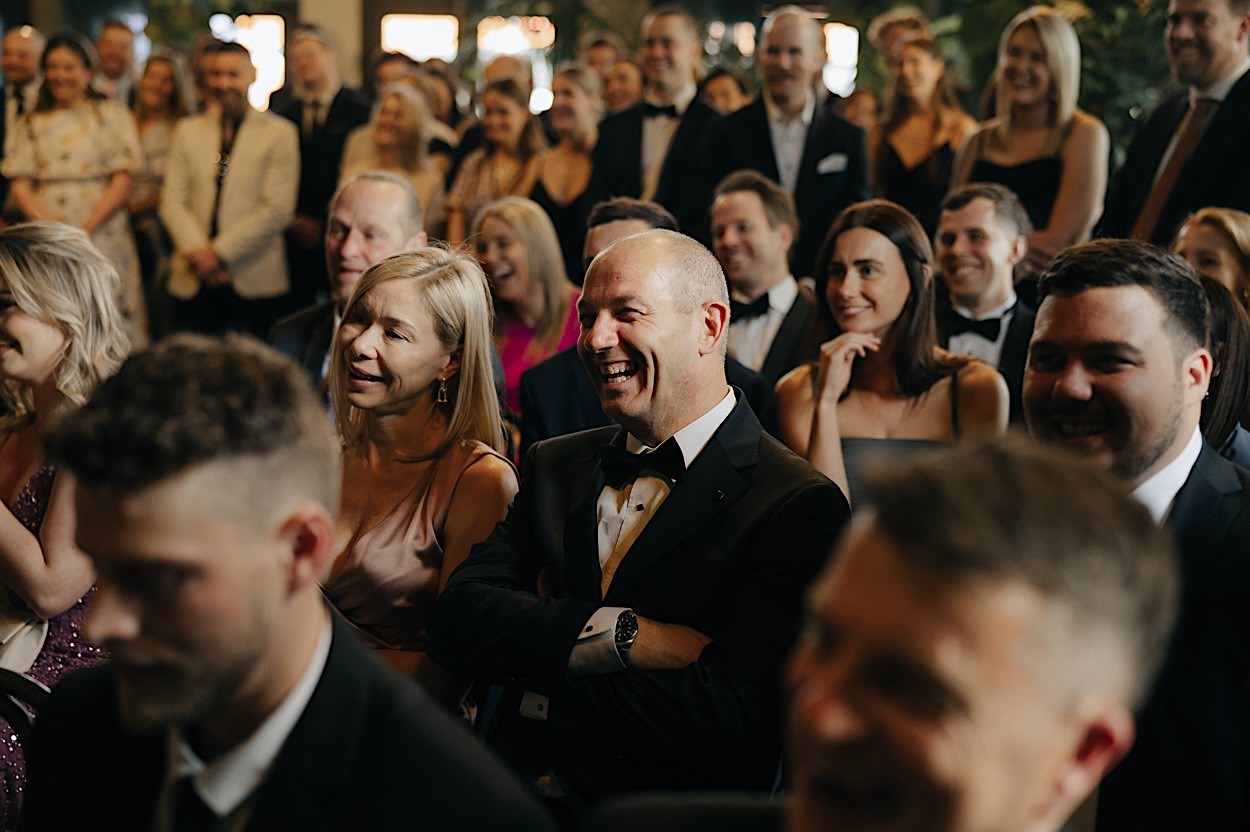 087_guest-laughing-vows-glasshaus-brucke-wedding-melbourne Wedding guest laughing during vows at a Glasshaus Brucke wedding in Melbourne