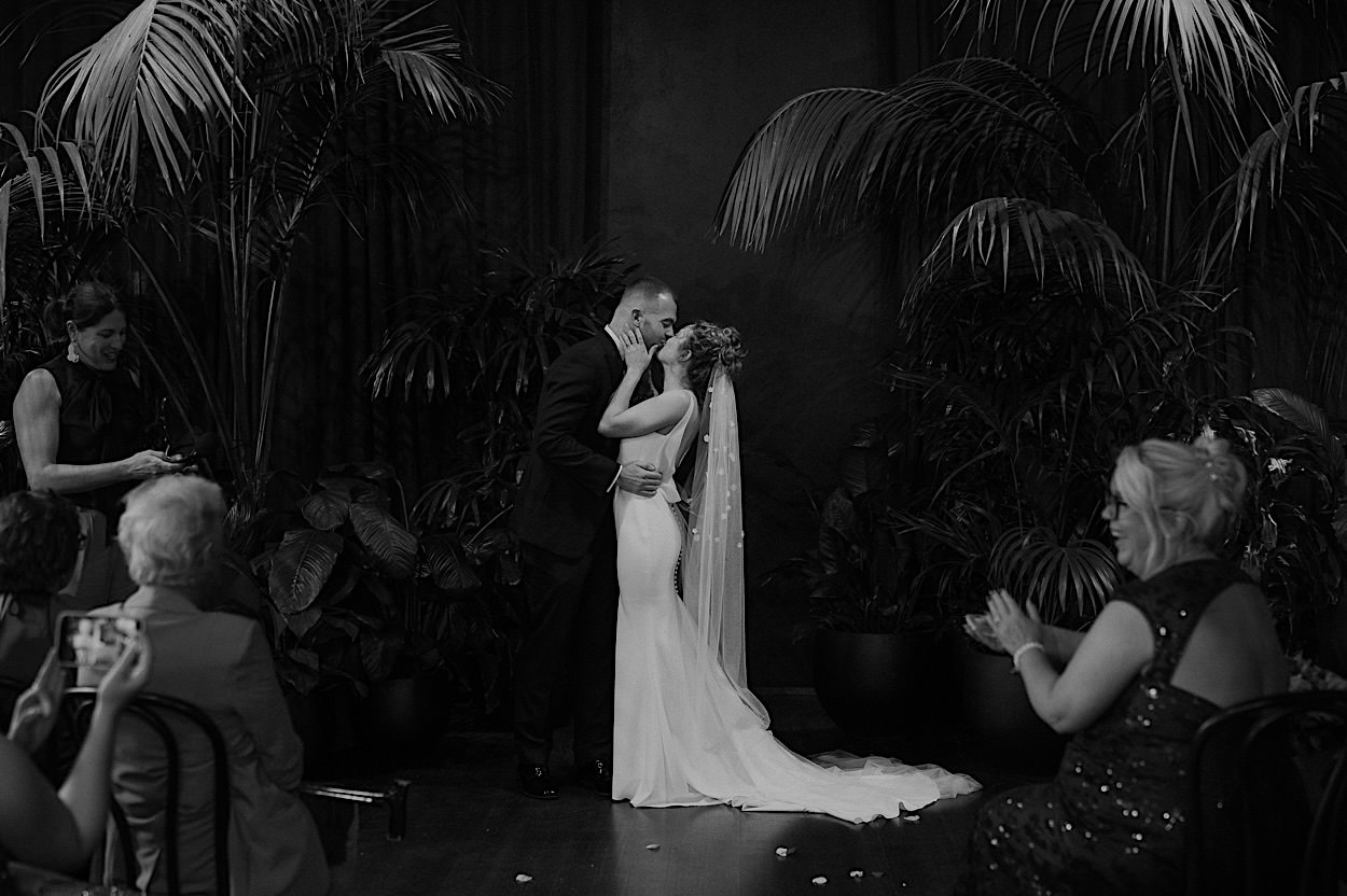 095_first-kiss-brucke-wedding-richmond-melbourne Couple sharing their first kiss as newlyweds at their Glasshaus Brucke wedding in Richmond, Melbourne