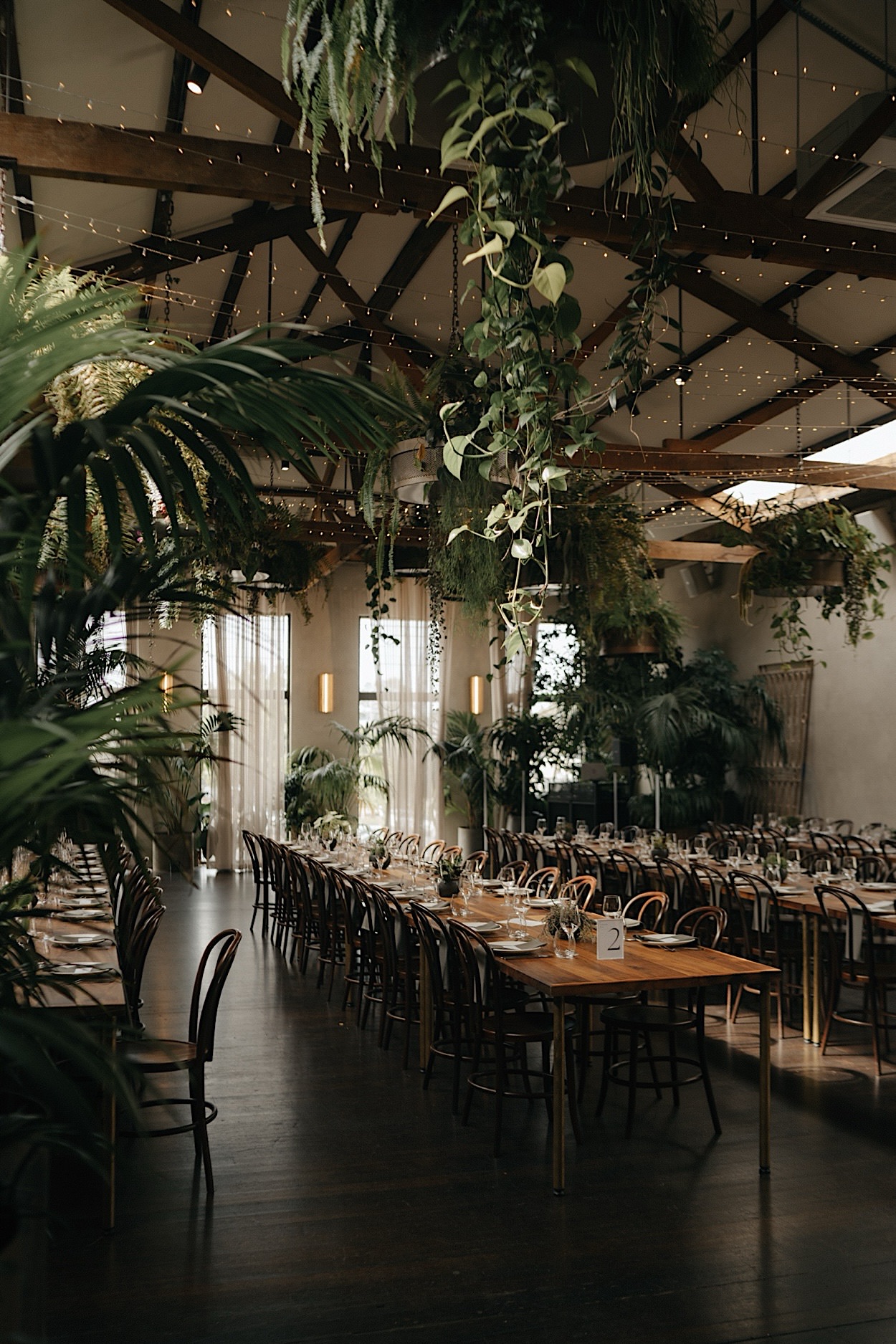 113_styling-glasshaus-brucke-wedding-richmond-melbourne Wide shot of the Glasshaus Brucke wedding space in Richmond, Melbourne, filled with lush greenery and elegant styling