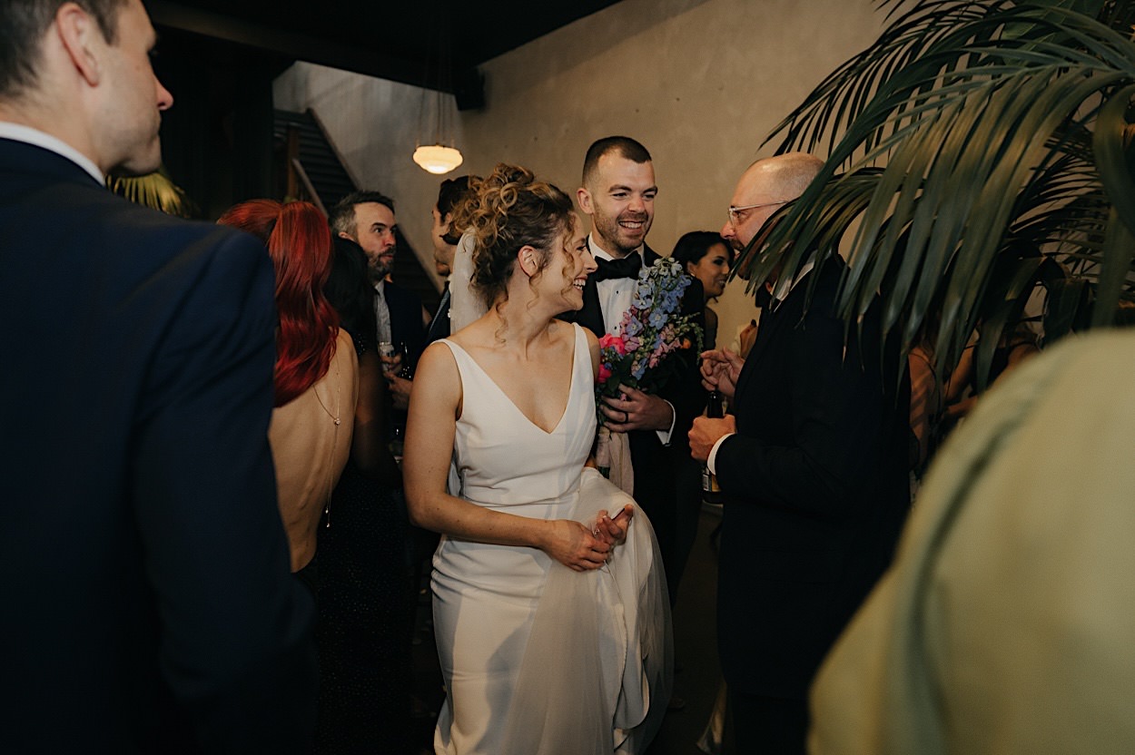 127_couple-mingling-glasshaus-brucke-wedding-richmond-melbourne Couple mingling and chatting with guests during their wedding reception at Glasshaus Brucke in Richmond, Melbourne