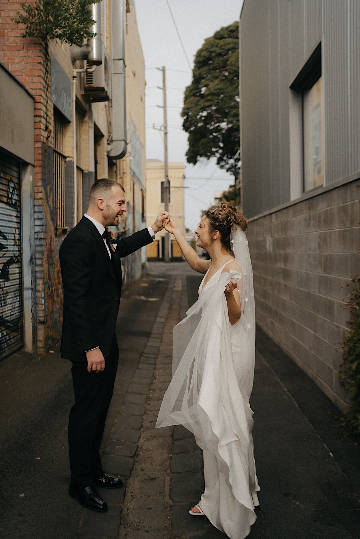 139_couple-dancing-portraits-glasshaus-brucke-reception Couple sharing a dance in the laneway during their reception at Glasshaus Brucke in Richmond, Melbourne