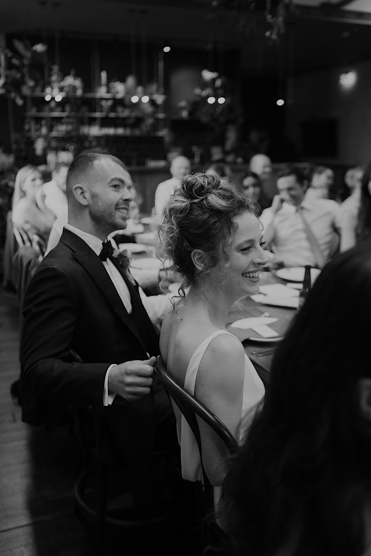 156_couple-smiling-reception-glasshaus-brucke-melbourne Black and white photo of the couple smiling and enjoying their wedding reception at Glasshaus Brucke in Melbourne