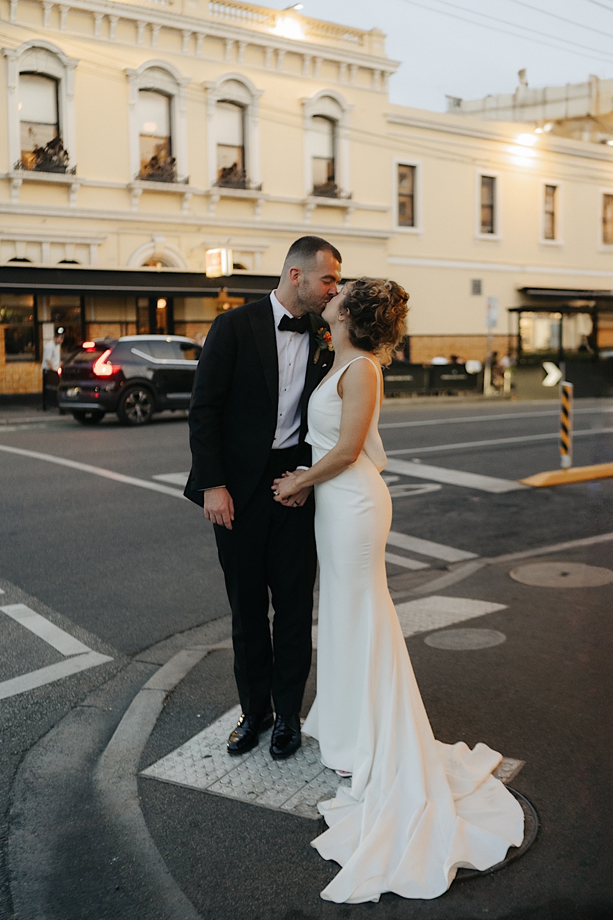 172_glasshaus-brucke-wedding-captured-by-melbourne-photographer Bride and groom standing on a street corner in Richmond, captured during their wedding at Glasshaus Brucke by a Melbourne photographer