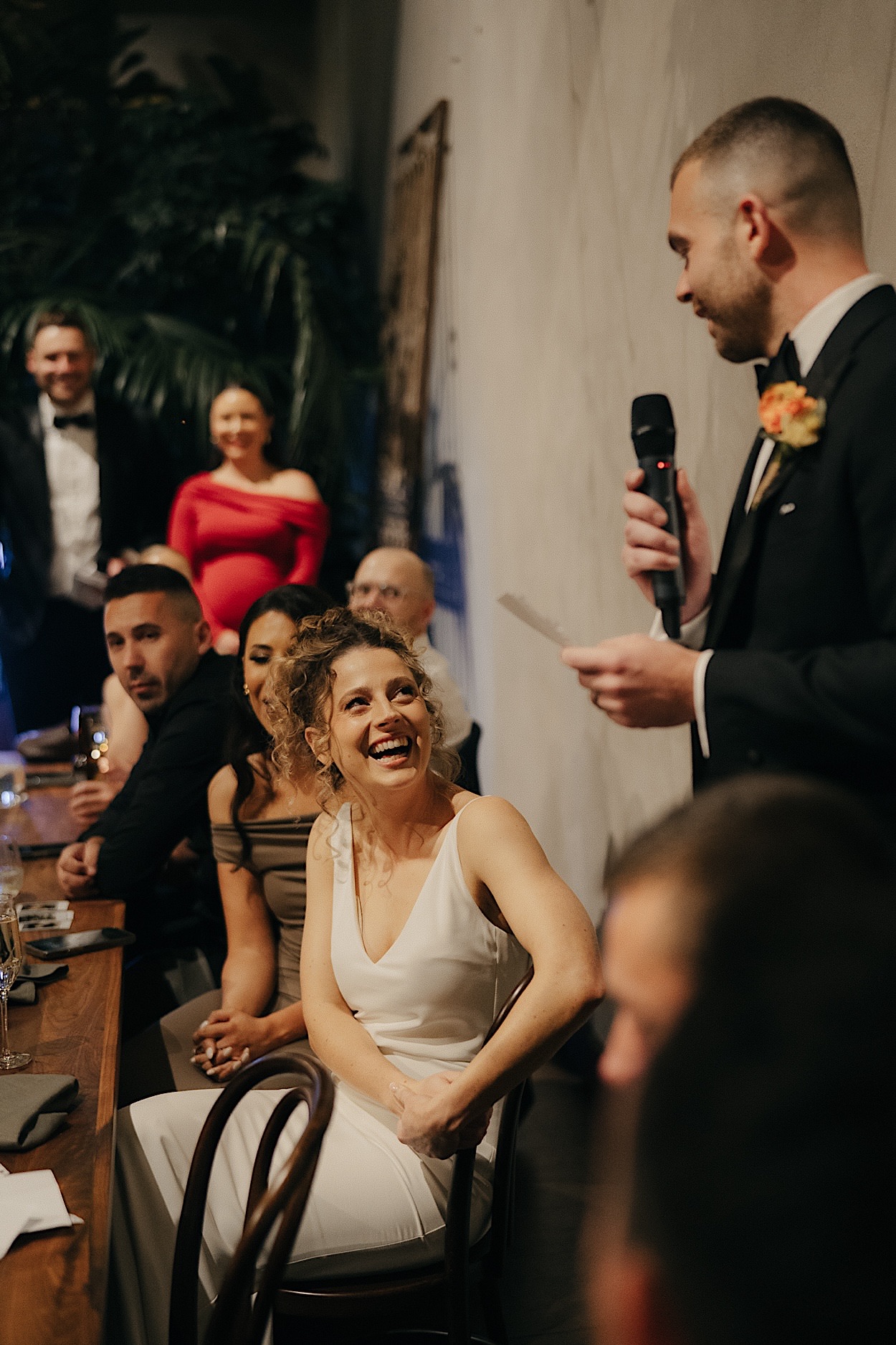 184_groom-speech-wedding-reception-at-glasshaus-brucke-richmond Groom giving a speech at the wedding reception at Glasshaus Brucke in Richmond, with the bride laughing