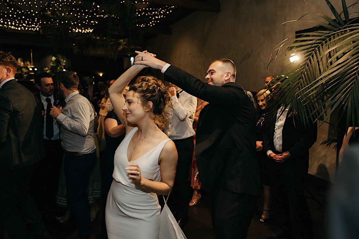 191_first-dance-glasshaus-brucke-captured-melbourne-photographer Bride and groom twirling during their first dance at a wedding at Glasshaus Brucke, captured by a Melbourne photographer