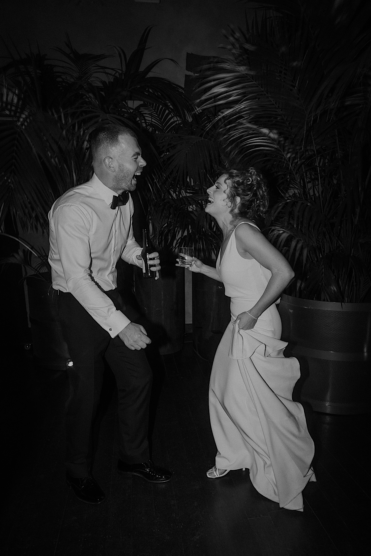 212_guests-dancefloor-glasshaus-brucke-wedding-melbourne-richmond Black and white photo of the bride and groom laughing with guests on the dancefloor at their wedding reception at Glasshaus Brucke in Richmond, Melbourne