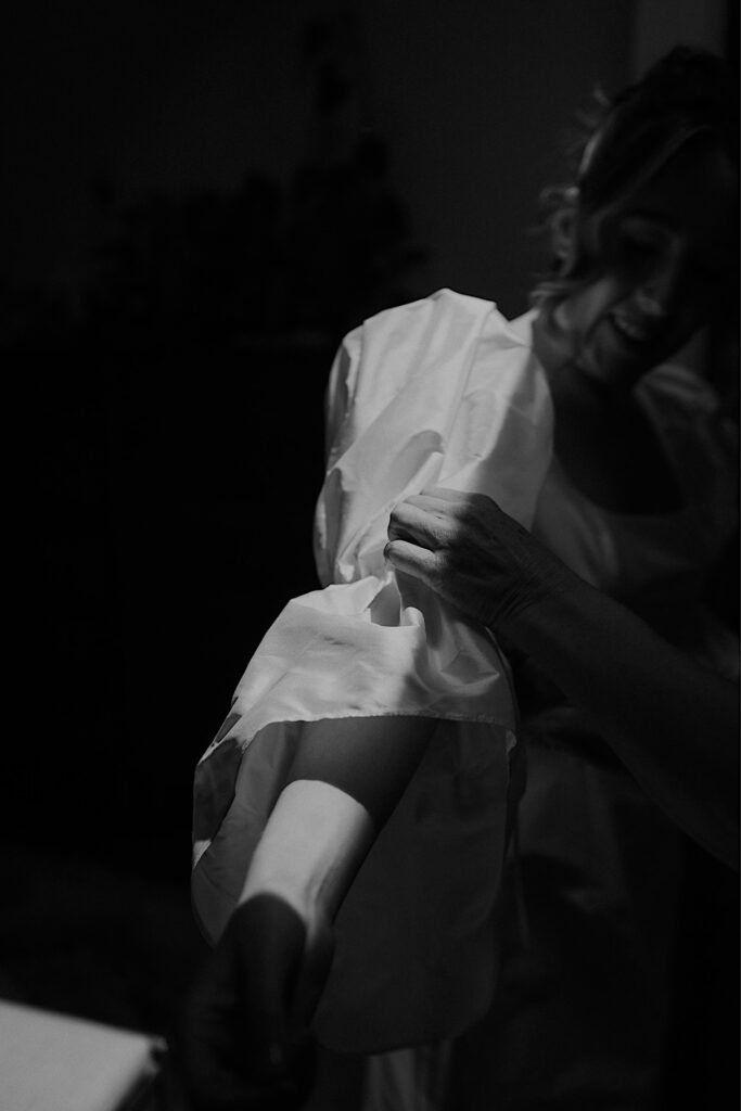 026_bride-dress-details-before-altar-electric-wedding-collingwood Black and white close-up of the bride’s dress details before the ceremony at Altar Electric, Collingwood, with soft mood lighting