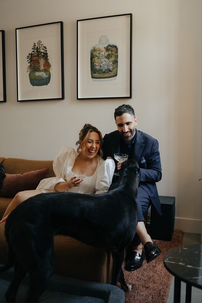 034_couple-having-toast-before-altar-electric-ceremony-melbourne Couple having a toast before their ceremony at Altar Electric, Collingwood, Melbourne, with their greyhound joining them