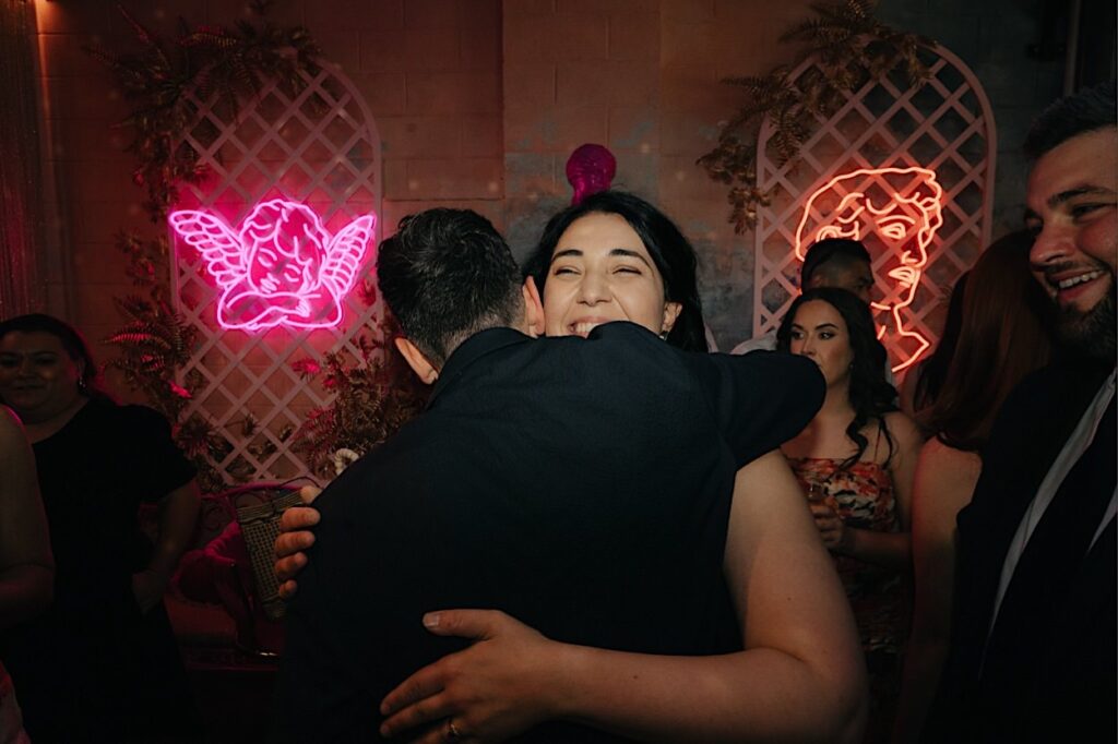 108_groom-hugging-guest-altar-electric-wedding-collingwood-melbourne Groom hugging a guest at the Altar Electric wedding in Collingwood, Melbourne.