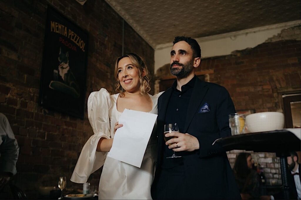 164_couple-listening-to-speeches-maggies-snacks-and-liquor-wedding Bride and groom listening intently to speeches during their wedding reception at Maggie’s Snacks and Liquor, Brunswick East, Melbourne