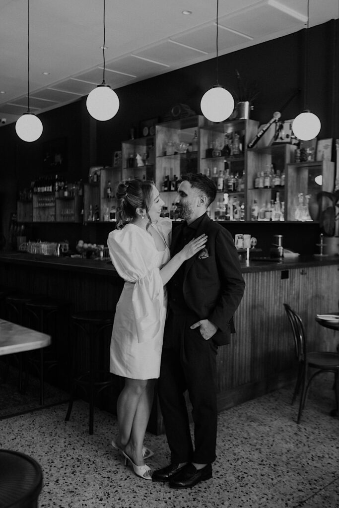 182_couple-portraits-maggies-snacks-and-liquor-wedding-melbourne Black and white portrait of bride and groom in front of the bar at Maggie’s Snacks and Liquor wedding in Melbourne