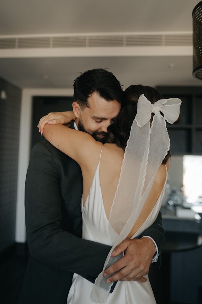 Couple sharing a cuddle during their first look before the Glasshaus Inside wedding in Cremorne