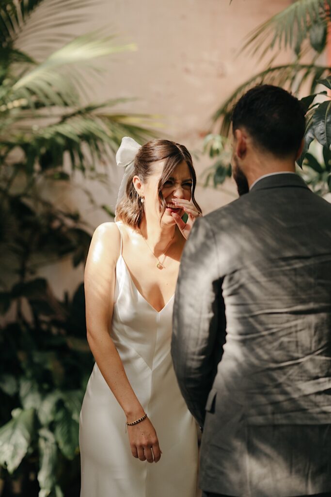 Bride laughing joyfully during the Glasshaus Inside wedding ceremony in Cremorne