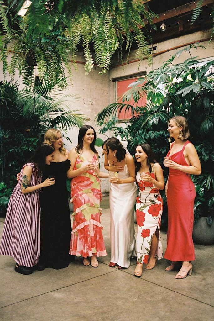 Bridesmaids enjoying a moment together during a Glasshaus Inside wedding in Cremorne, captured on 35mm film.