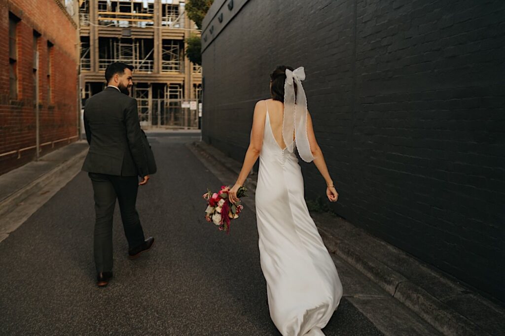 The couple poses for portraits just before their Glasshaus Inside wedding reception in Melbourne.