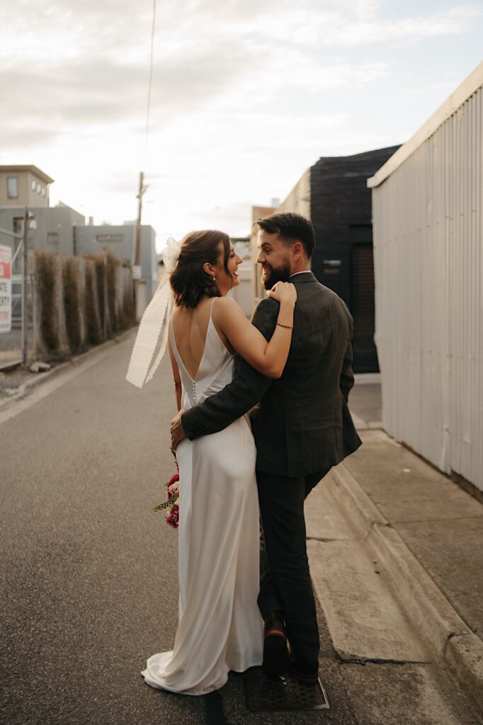Shot from behind the couple as they look at each other before their Glasshaus Inside wedding reception in Cremorne.